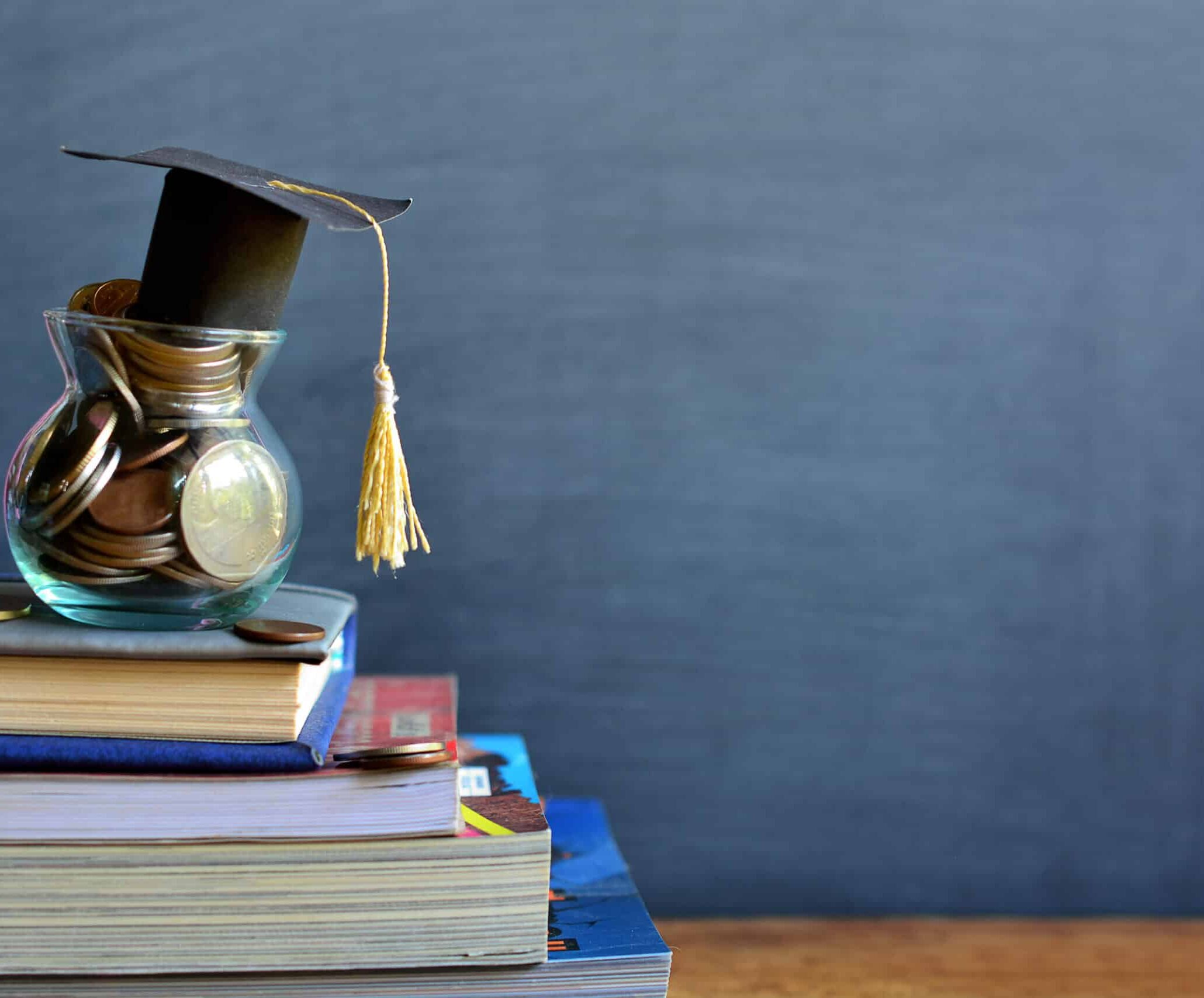 Pot with coins on top of books to represent scholarship